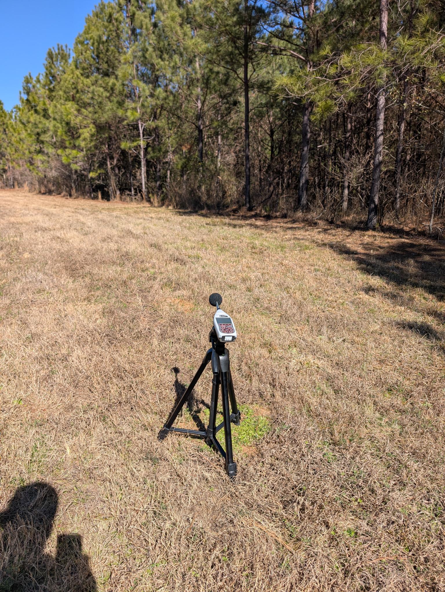 Outdoor sound level meter positioned at a receptor location for environmental noise compliance measurement.