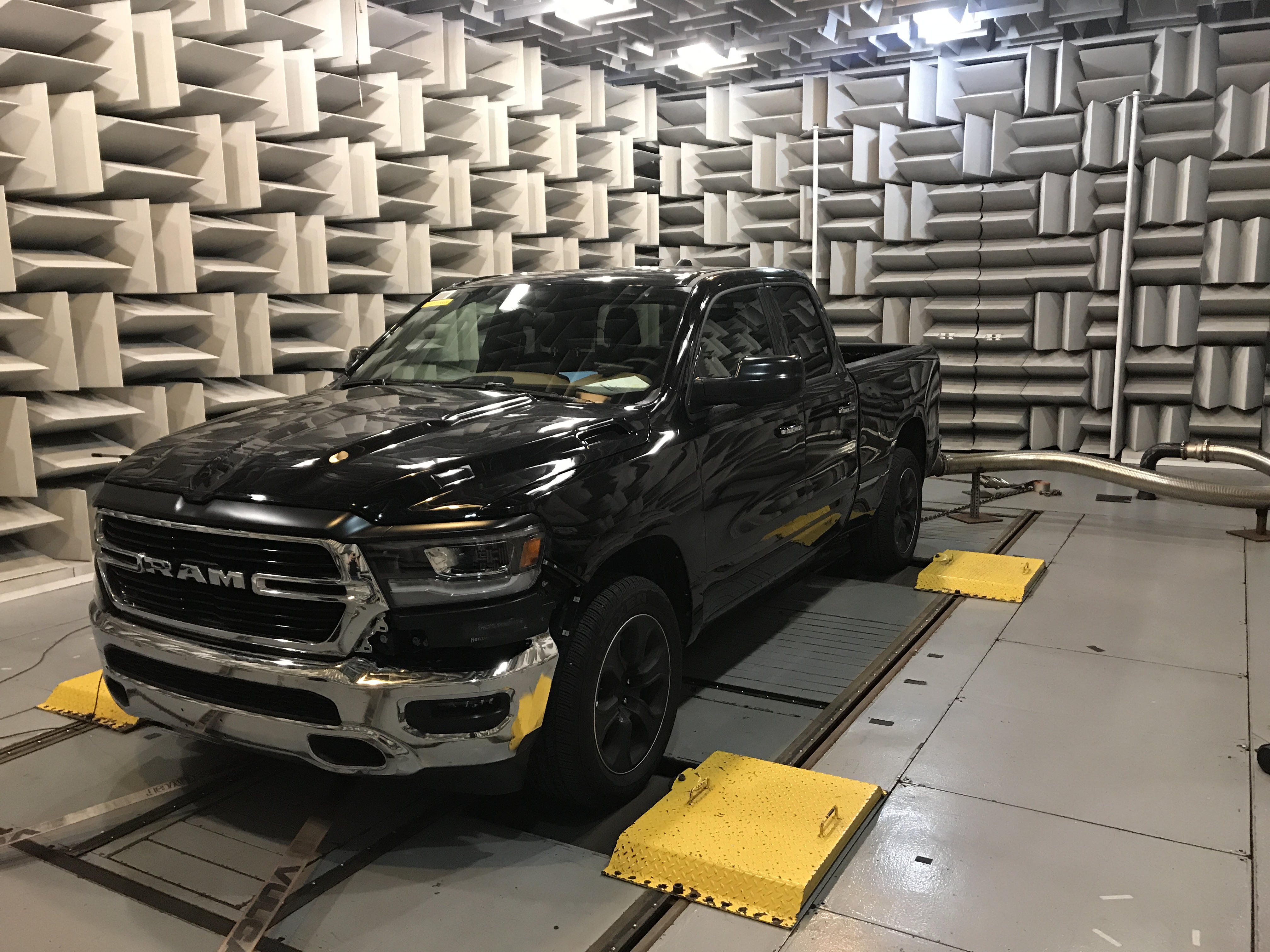 Vehicle positioned in a controlled acoustics test chamber for formal measurement and validation work.