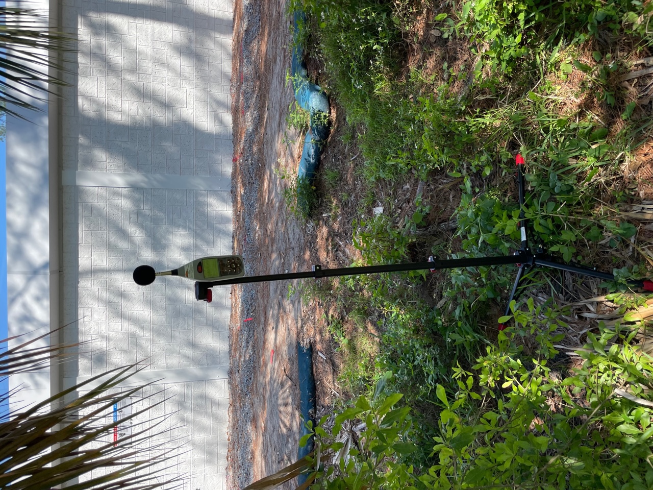 Sound level meter positioned near a completed barrier condition to evaluate mitigation performance in the field.